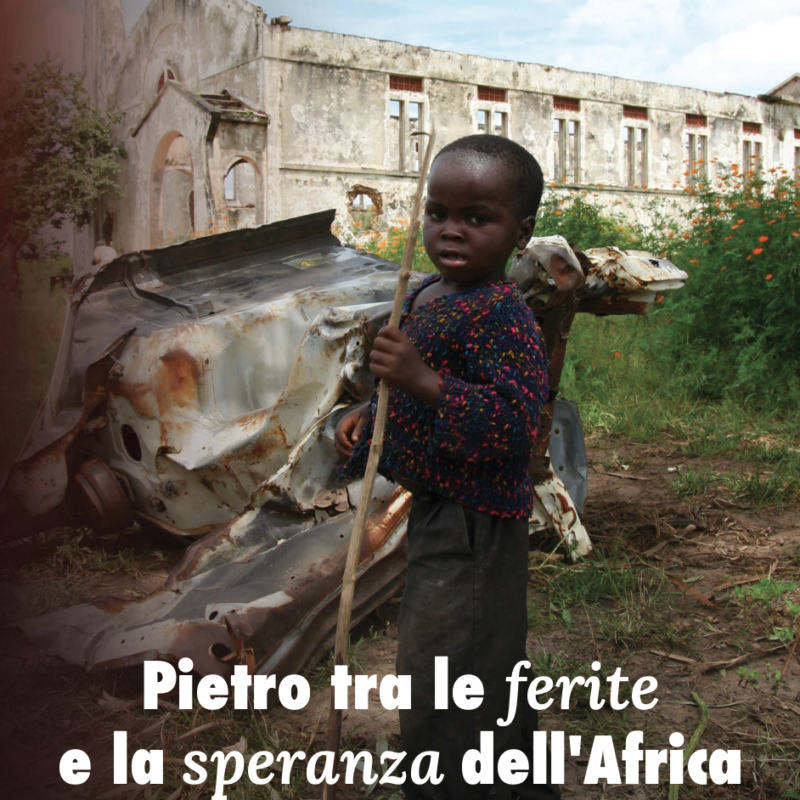 Bambino in Angola davanti a un edificio in rovina: la copertina dell'Eco dell'Amore 4 di ACS Italia